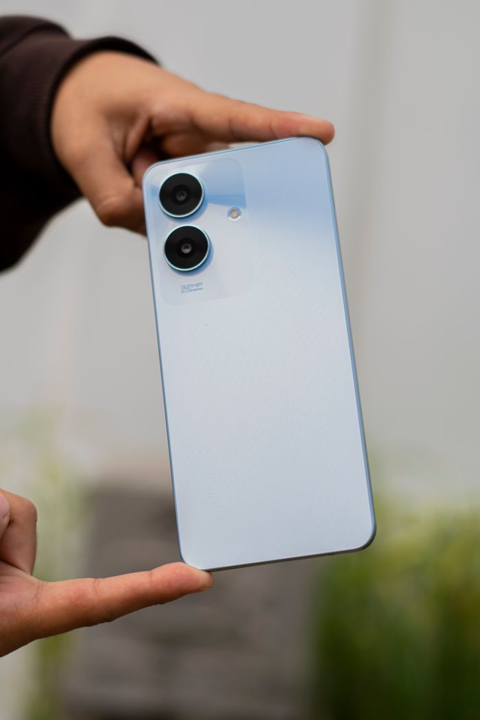 Close-up shot of a sleek smartphone with dual cameras held outdoors, perfect for tech enthusiasts.